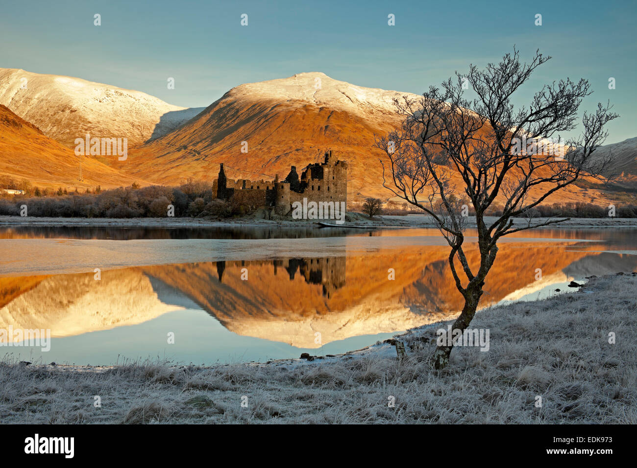 Kilchurn Castle reflected in Loch Awe, with  Snowcapped mountains Argyll and Bute, Scotland UK Stock Photo