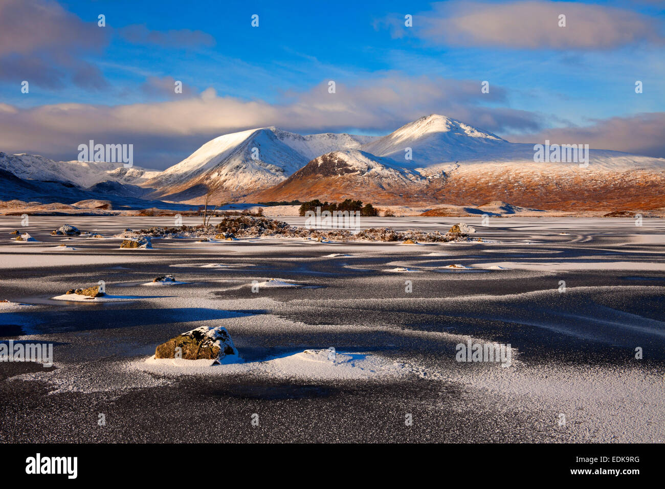 Frozen ice covered Lochan na-h Achlaise Rannoch Moor with snow covered Black Mount in background Lochaber Scotland UK Stock Photo