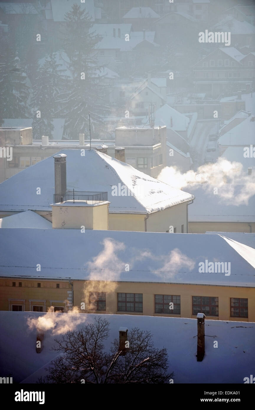 Winter morning urban scene with roofs covered in snow Stock Photo