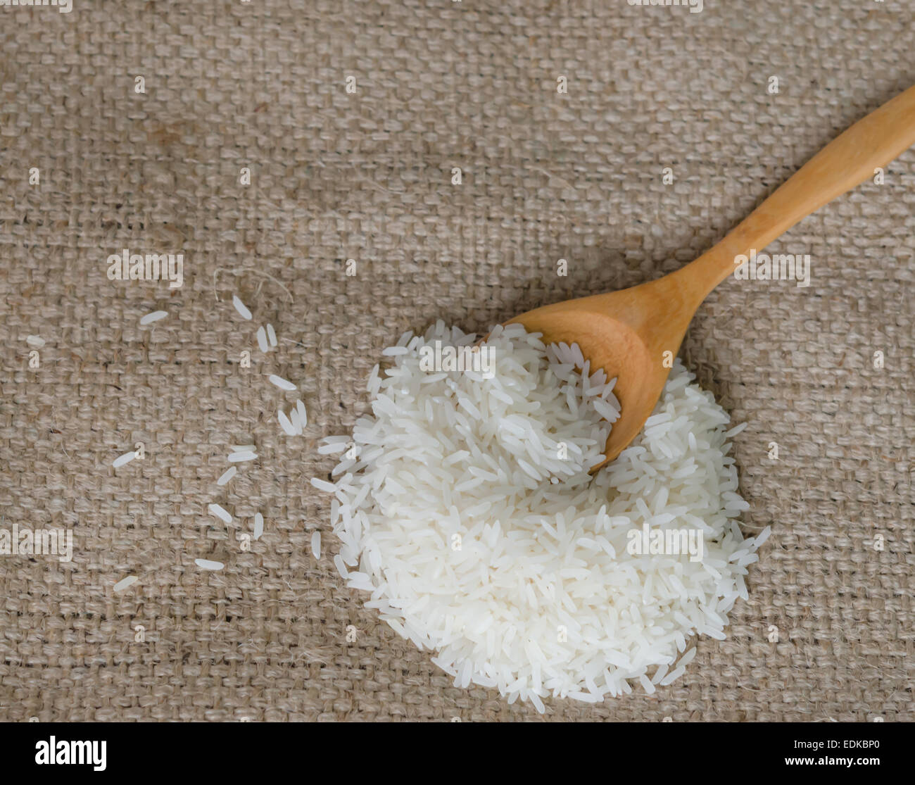 white rice grains with wooden spoon on sackcloth Stock Photo - Alamy