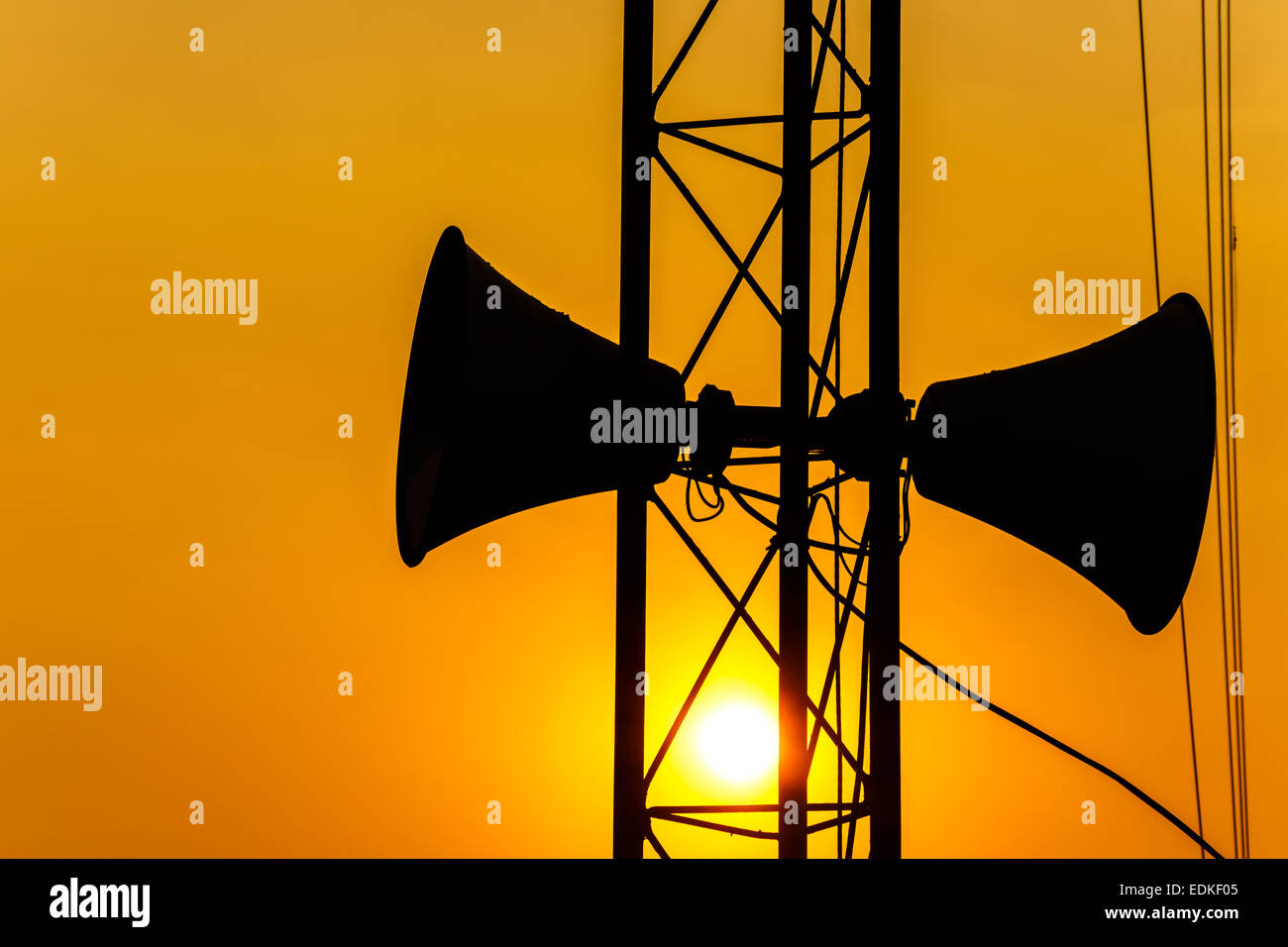 loudspeaker on pillar and sunset in the evening (silhouette) in Thailand Stock Photo