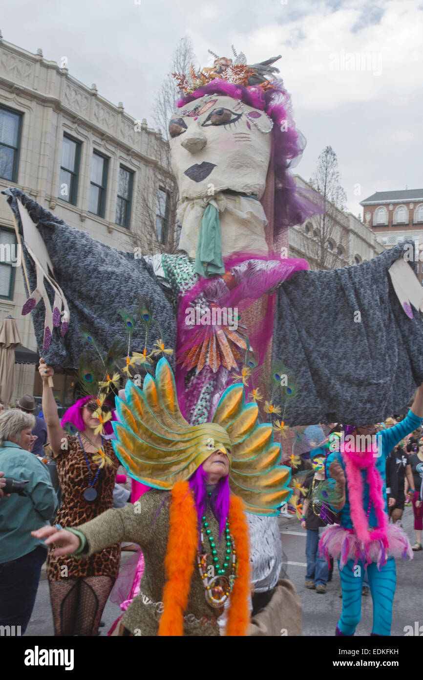 Happy people in colorful costumes with a creative effigy participate in the Asheville, NC Mardi Gras parade Stock Photo