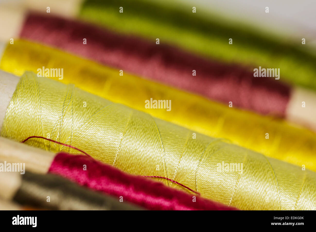 Colorful Sewing Thread Pattern. Colorful miniature bobbins of thread