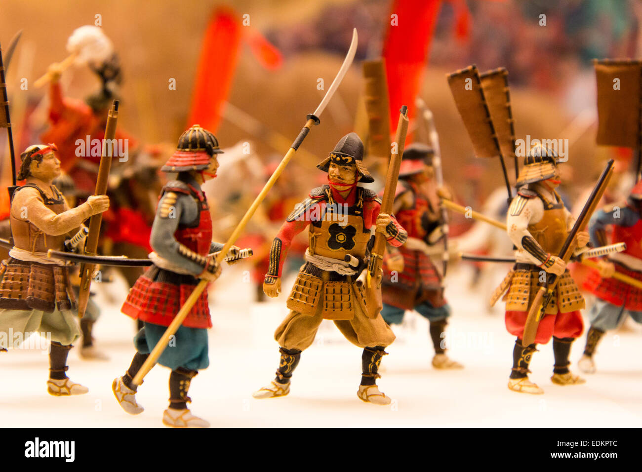 Exhibit model of a Japanese medieval battle with samurai soldiers. Close up of some of the model figurers, many carrying banners on their backs. Stock Photo