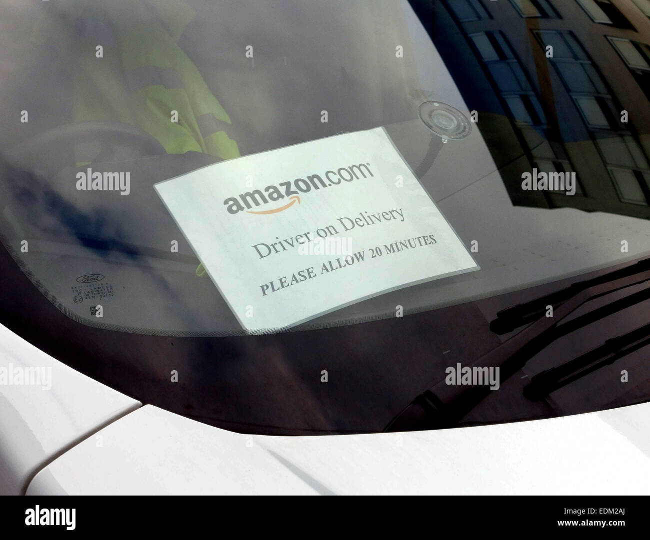 Sign on windscreen of van making delivery for Amazon in London Stock Photo