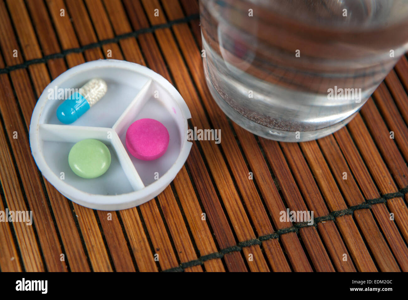 pills pillbox and a glass of water Stock Photo