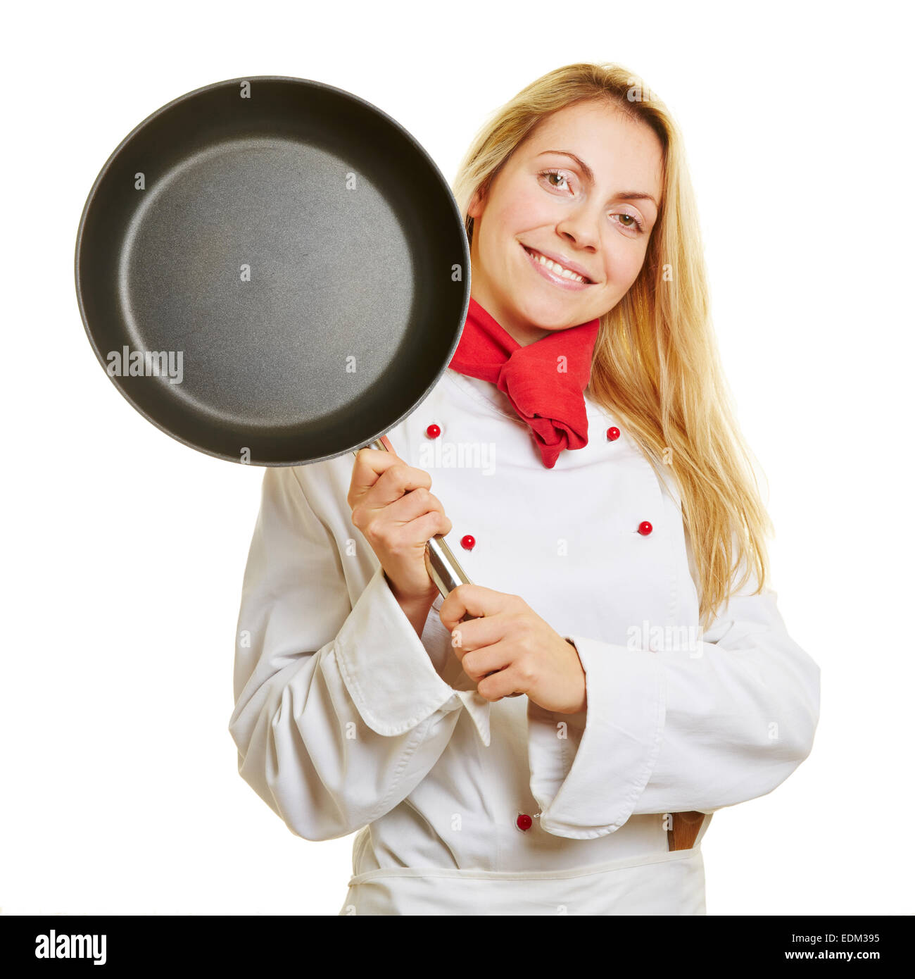 Vegetables fry on a large frying pan on fire. Cooking at the festival. Girl  chef pouring vegetables into disposable utensils. Stock Photo