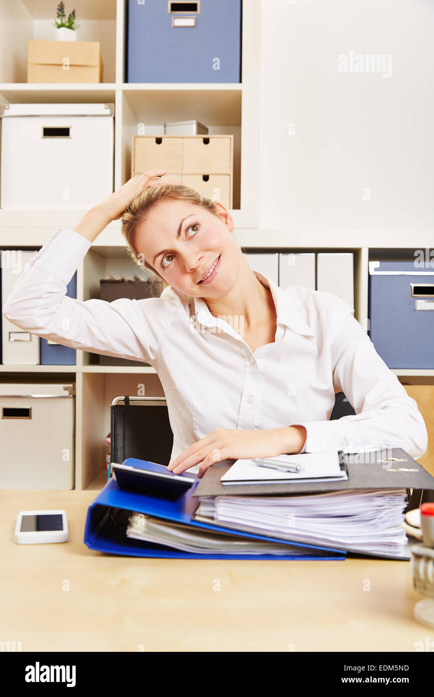 Young business woman in office stretching her tense nape with her hand Stock Photo