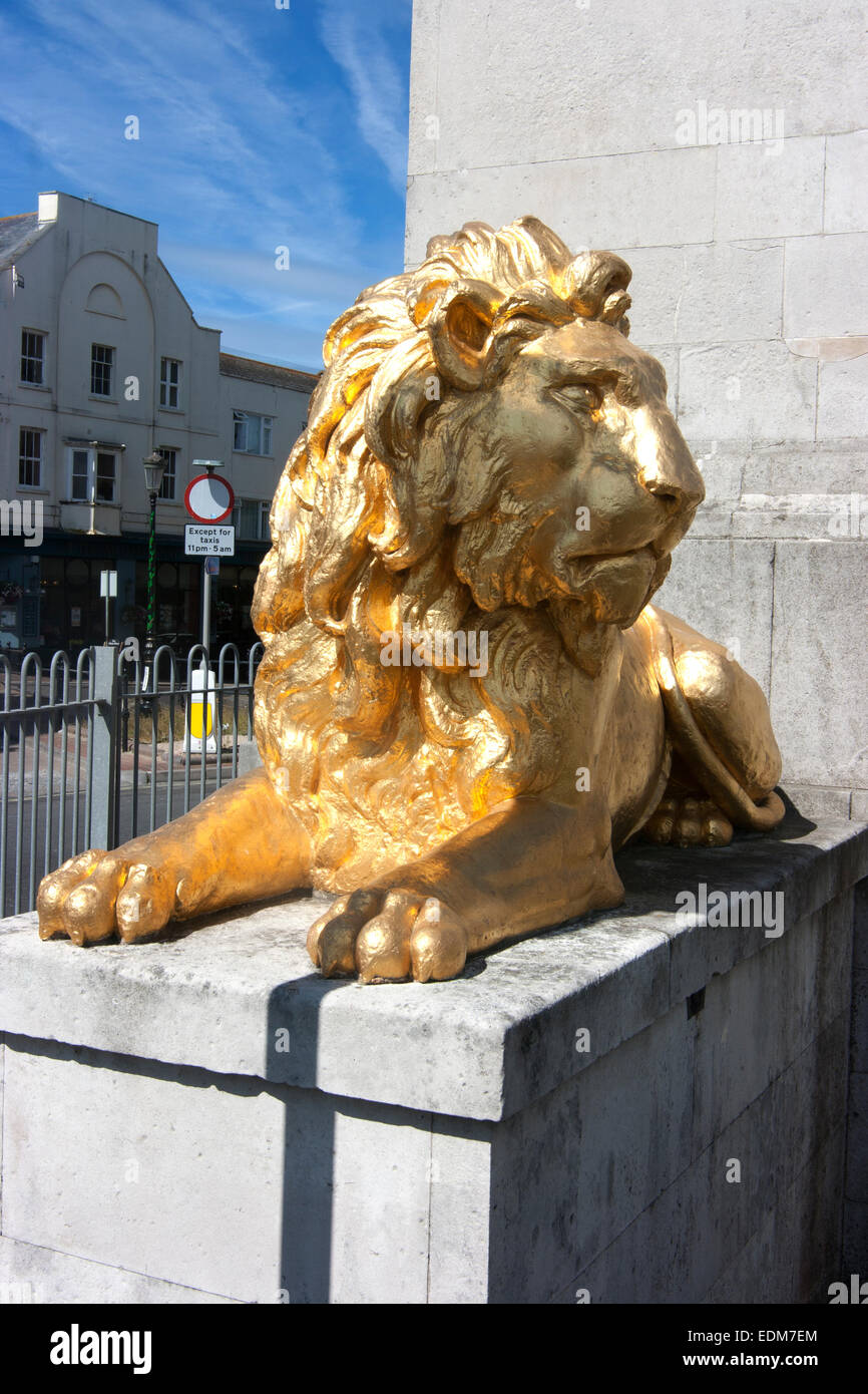 Gilded lion statue at base of statue of KIng George 111, Weymouth, Dorset, England Stock Photo