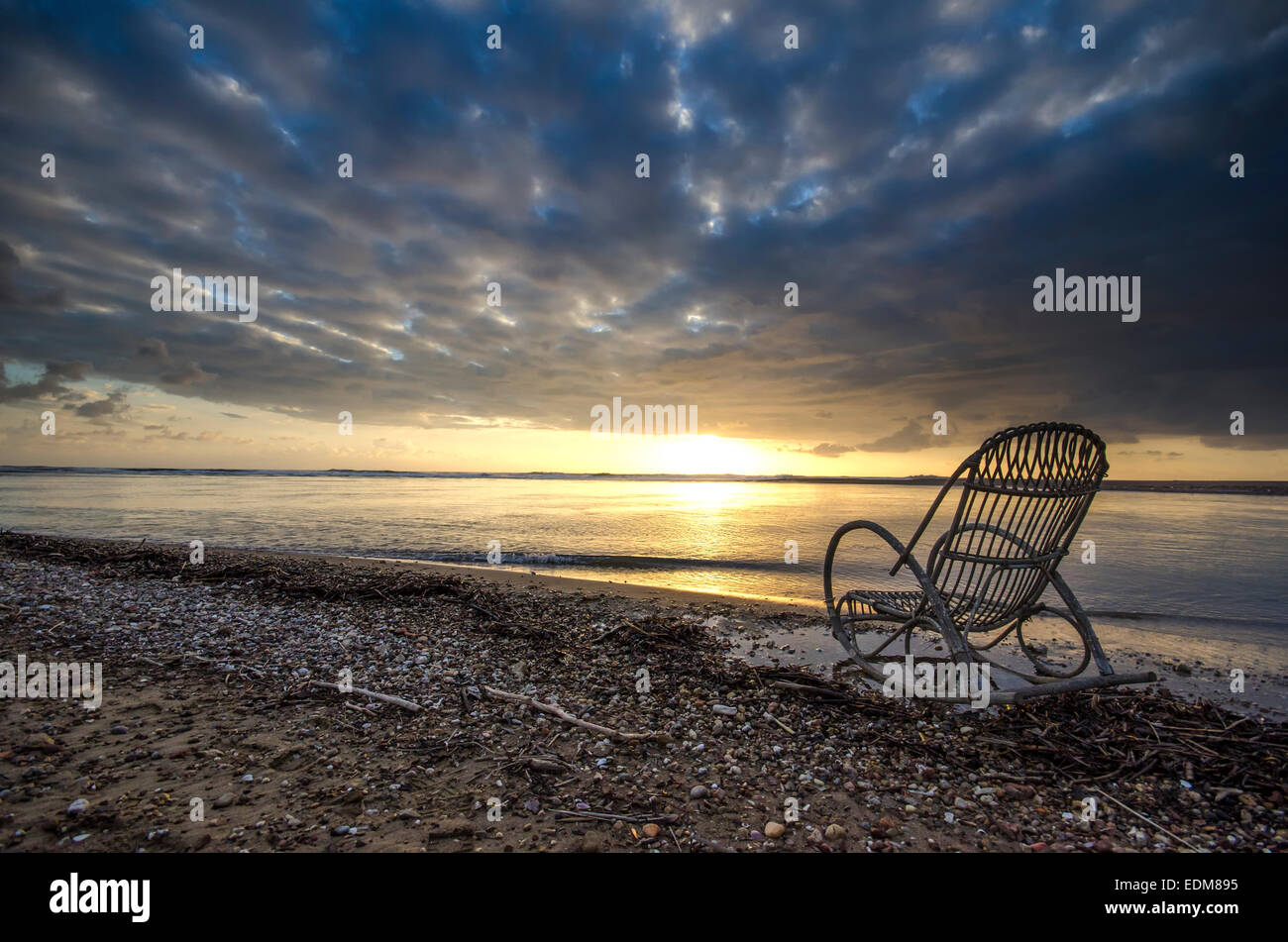 A empty chair stand on beach with view on sunset Greece Stock Photo