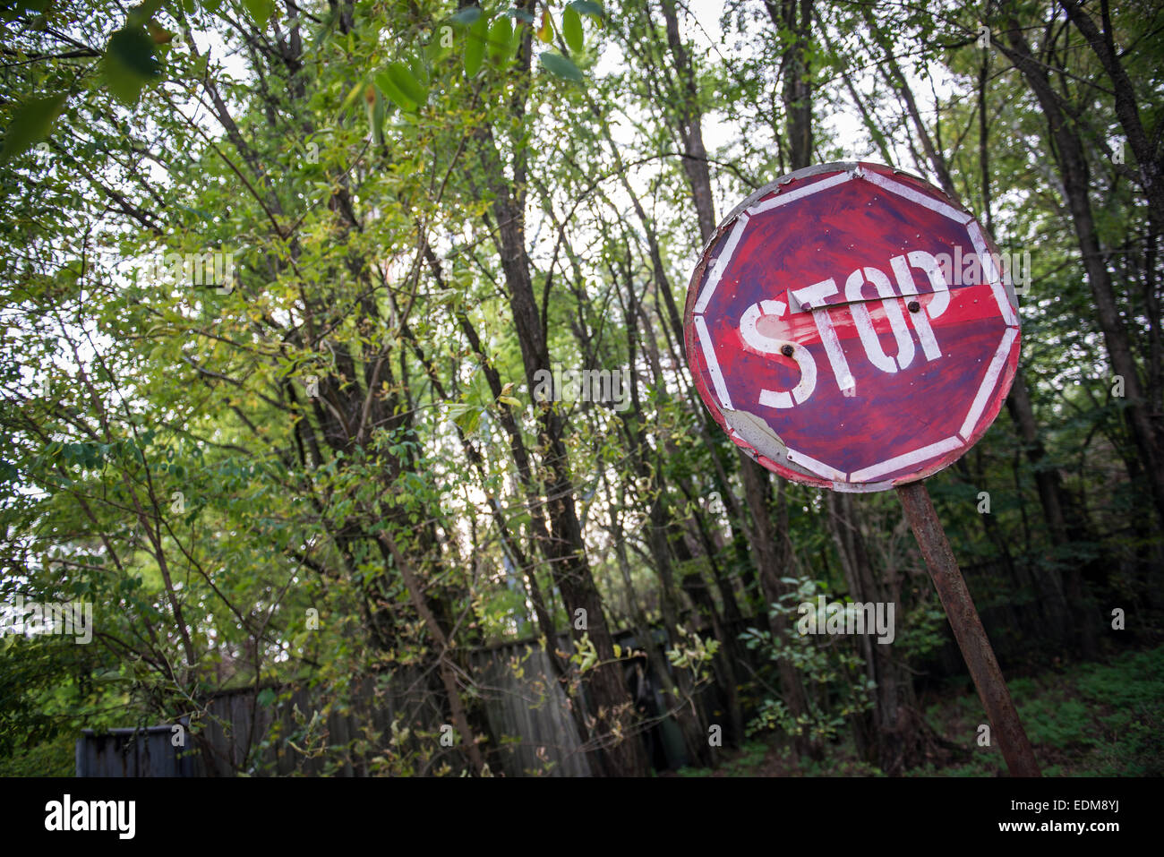 Stop Sign in Chernobyl-2 military base next to Duga-3 Soviet radar in Chernobyl Exclusion Zone, Ukraine Stock Photo