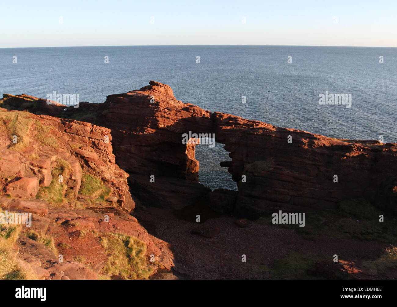 Needle E'e rock arch in red sandstone Seaton Cliffs Angus Scotland ...