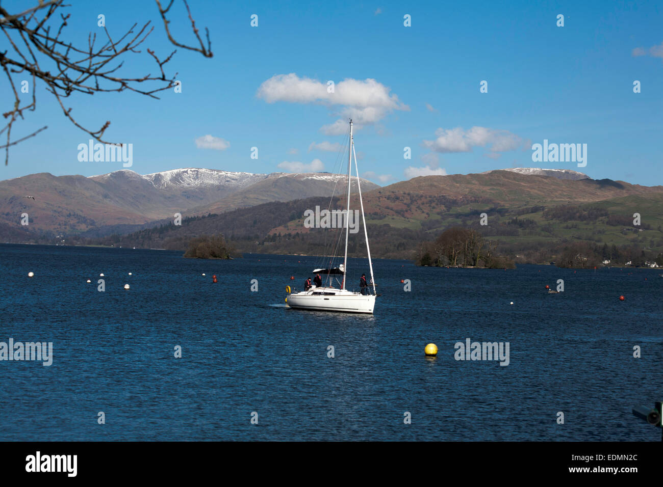 Yacht sailing on Windermere with The Fairfield Horseshoe above