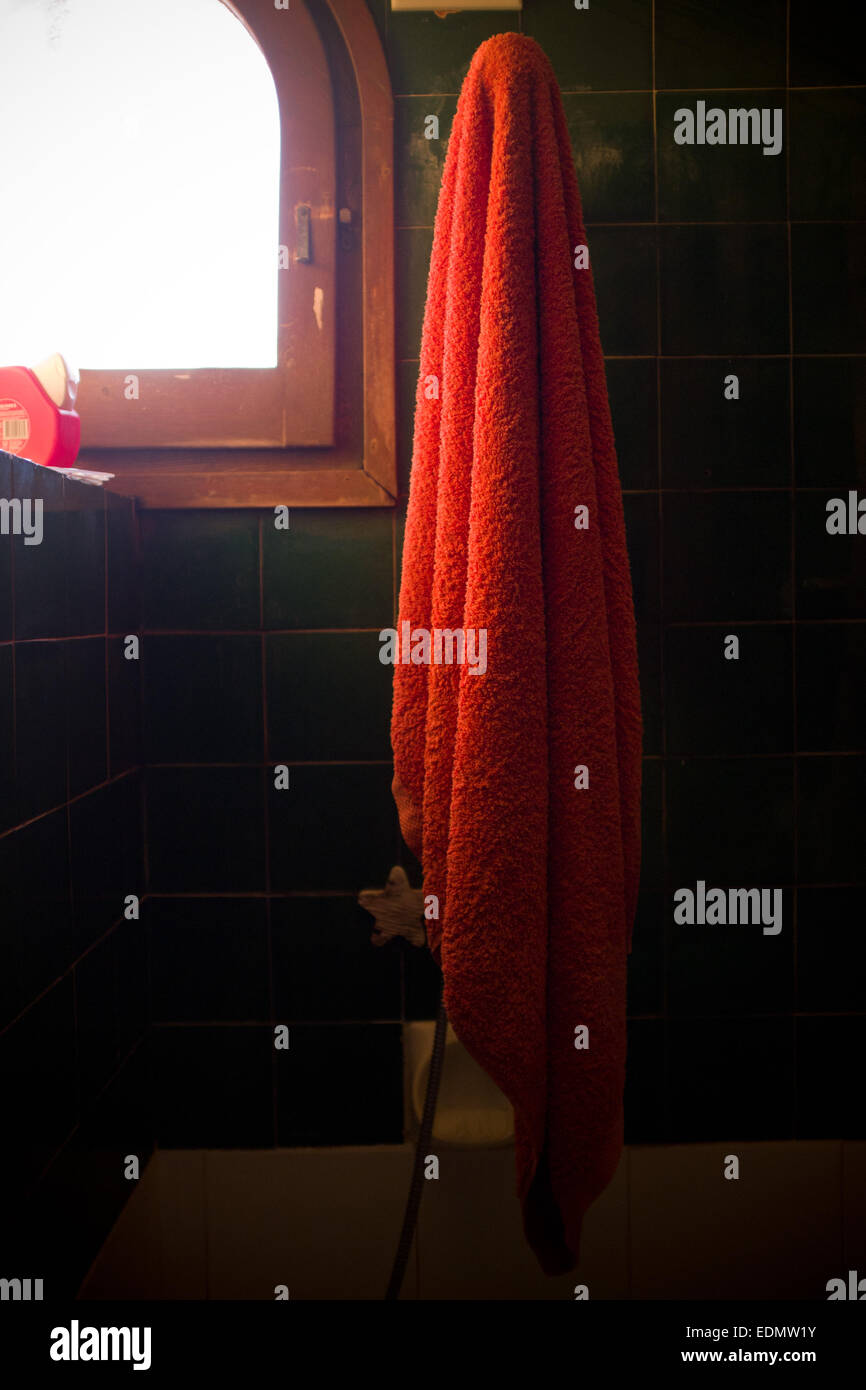 Red towel hanging in a shower Stock Photo
