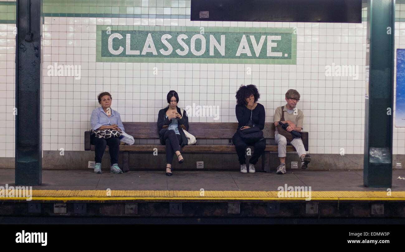 People wait for their subway train in New York City. Stock Photo
