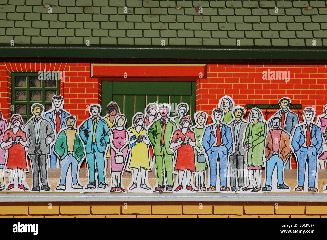 Watercolour cardboard cutout people commuters on toy station Stock