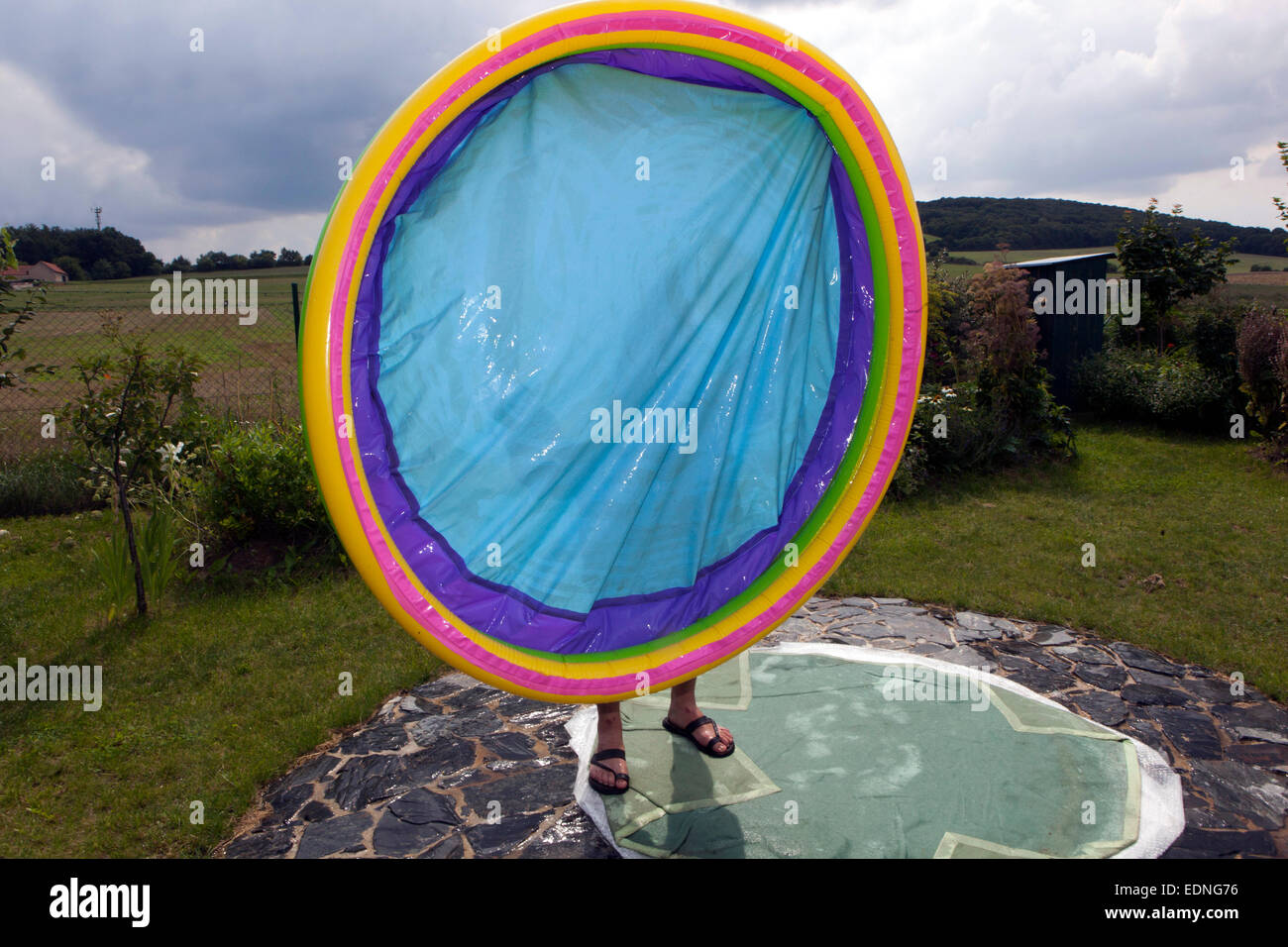 Draining an inflatable pool man Stock Photo Alamy