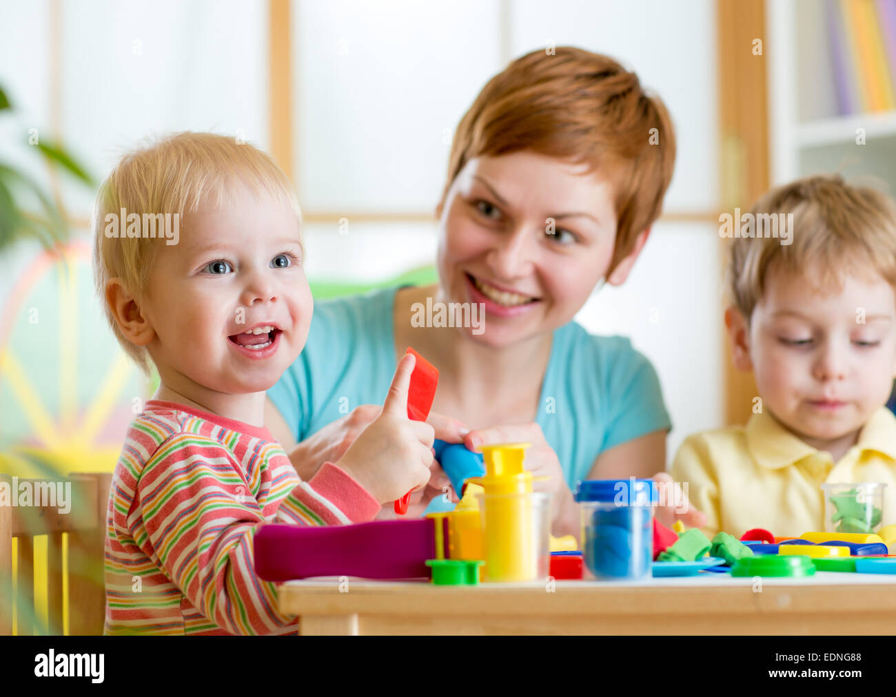 woman playing and teaching with children Stock Photo