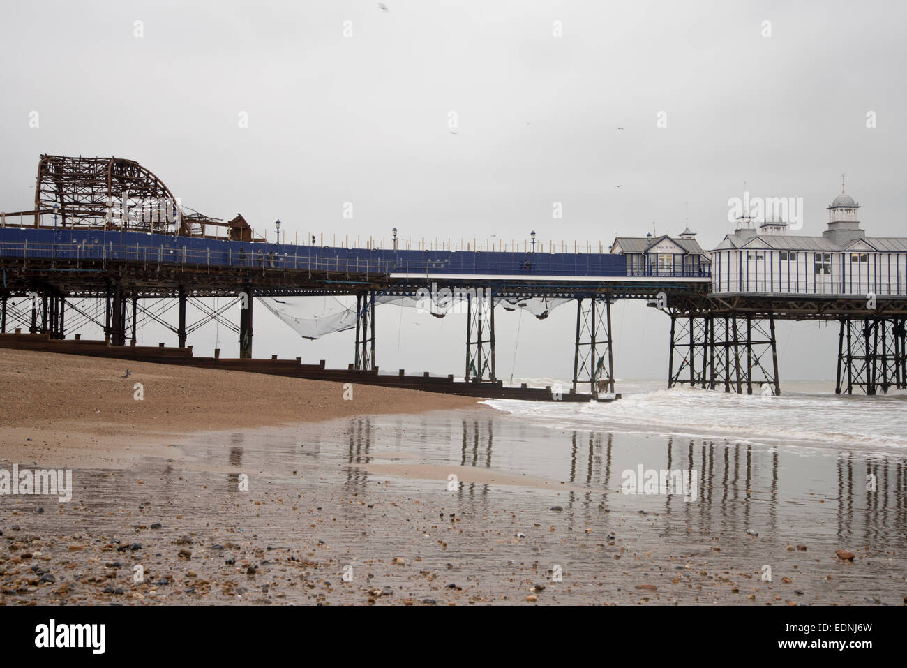 Eastbourne Pier, a grade II* listed building, showing the damaged portion and the netting added after the fire in Sept 2014 Stock Photo