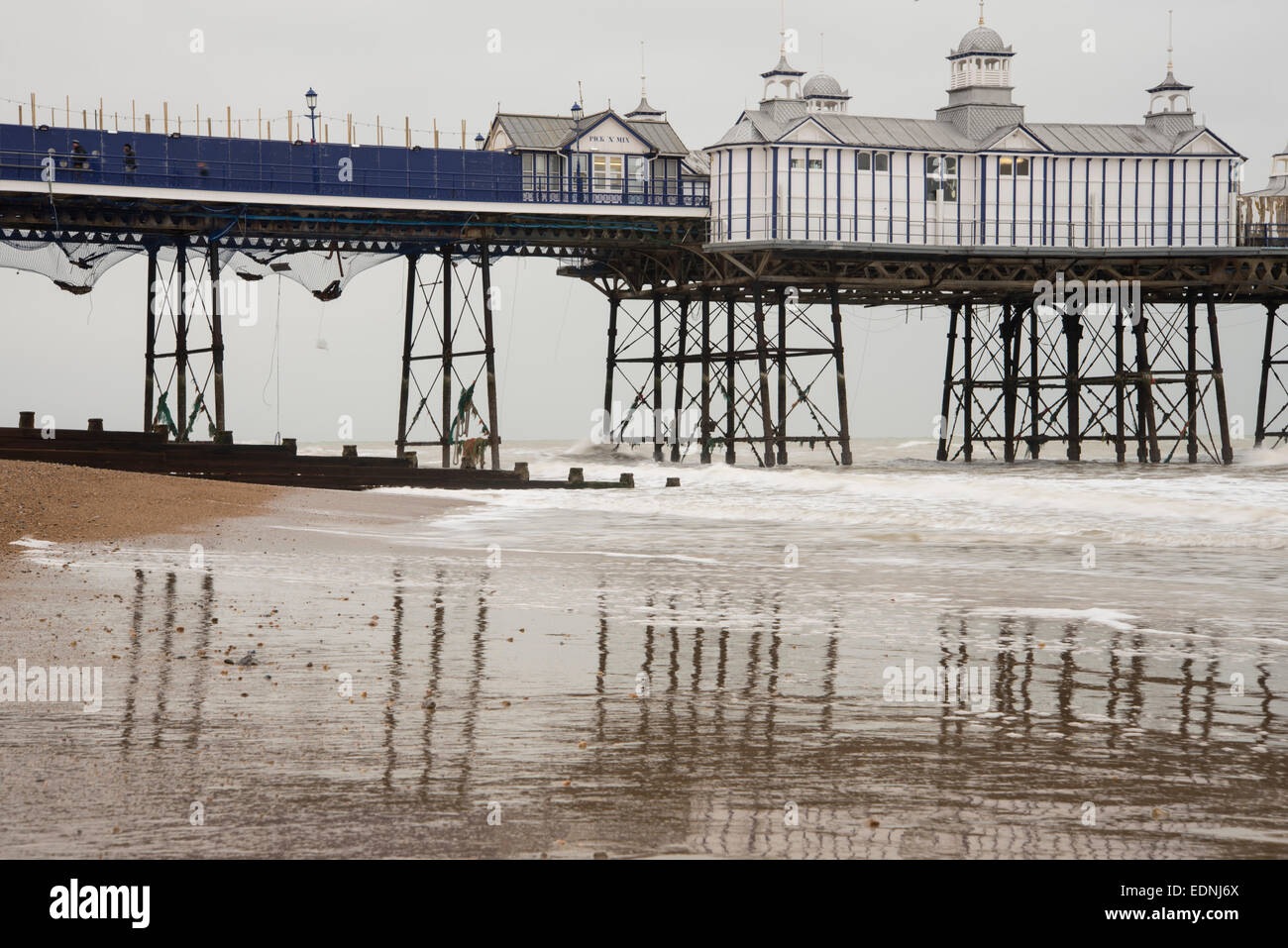 The iron struts and legs of Eastbourne Pier, a grade II* listed building, showing the netting added after the fire in Sept 2014 Stock Photo