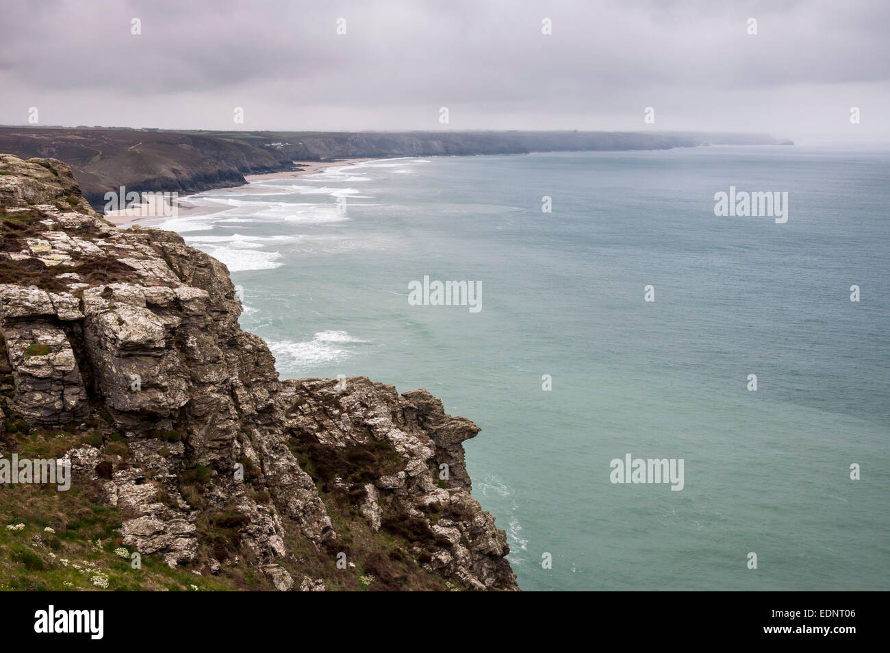 Dramatic rugged coastline near St Agnes in Cornwall on a rainy spring day. View along the coast towards Porthtowan. Stock Photo