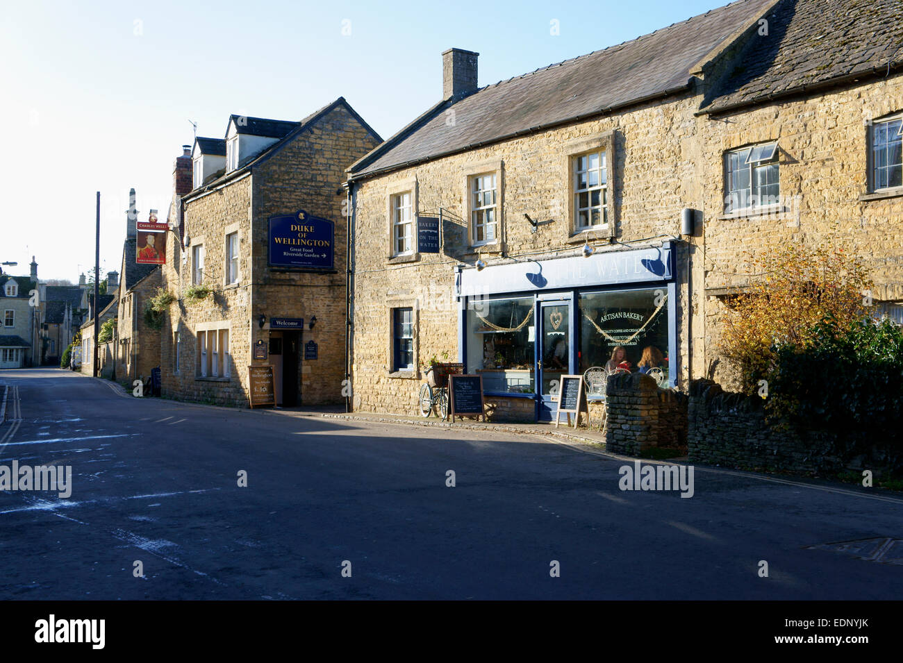 Quaint Cotswold Street with Bakery and village Inn at Bourtononthe