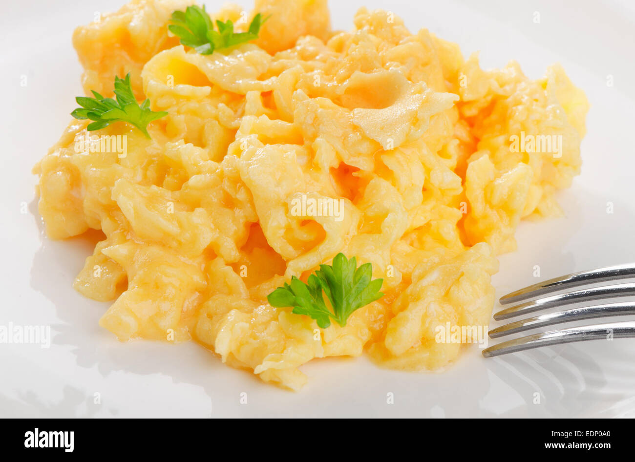 Scrambled eggs with fresh herbs. Selective focus Stock Photo - Alamy