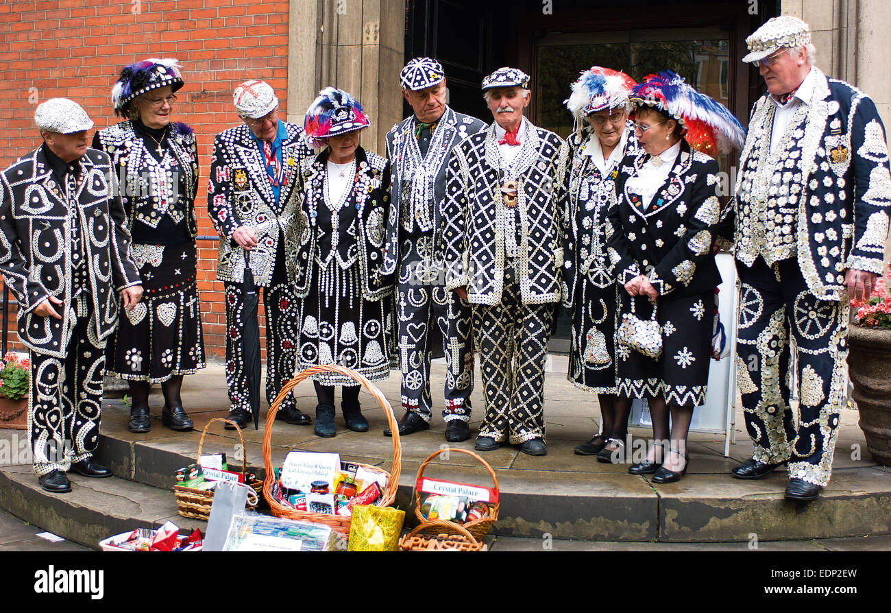 A large group of Pearly Kings and Queens from gather for the Harvest Festival Service at St. Paul’s Church in Covent Garden. Stock Photo