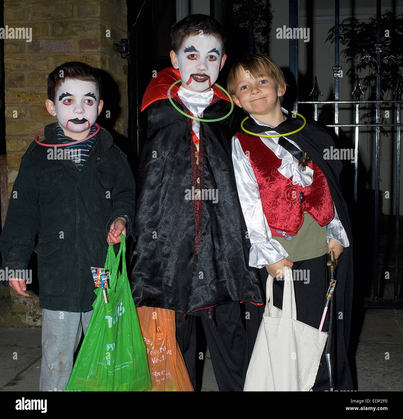 Three American children go trick or treating in St. John's Wood on Halloween. Stock Photo