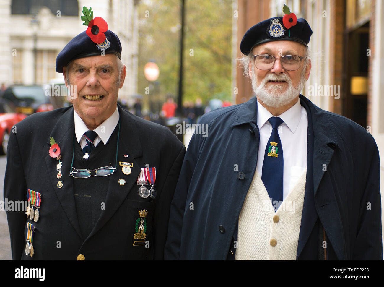 Two elderly veterans proudly display their caps and medals in Whitehall on Remembrance Sunday. Stock Photo