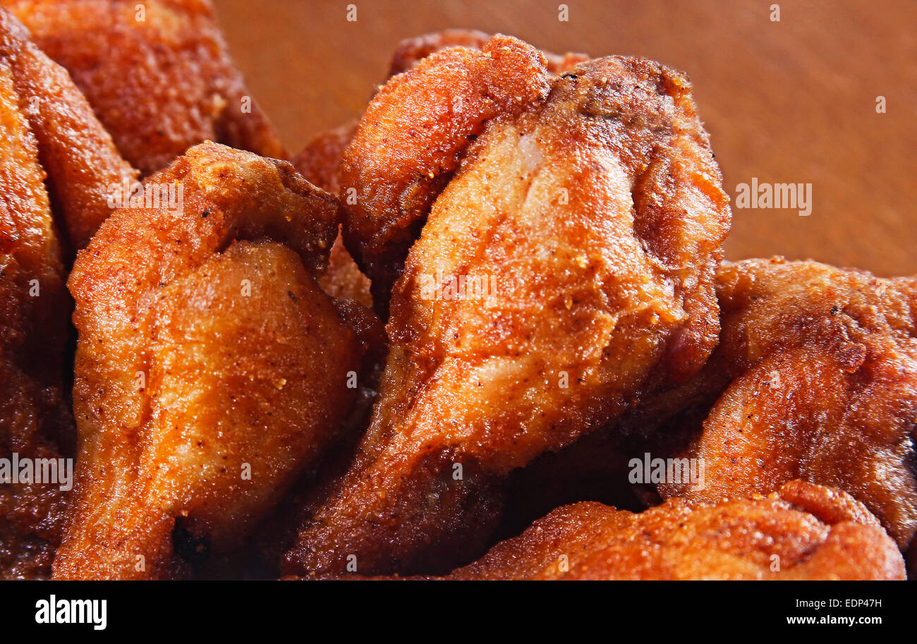 A close up of golden brown fried chicken thighs Stock Photo - Alamy