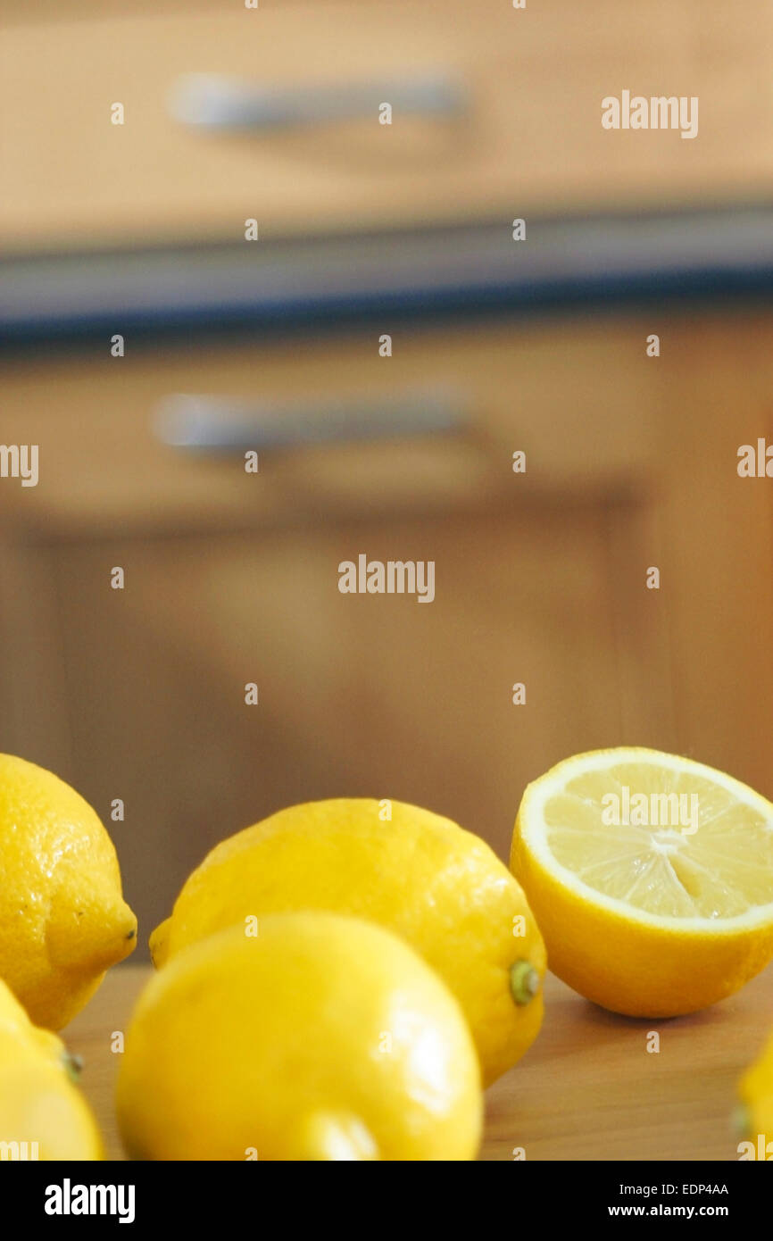 Fresh lemons on a kitchen worktop Stock Photo