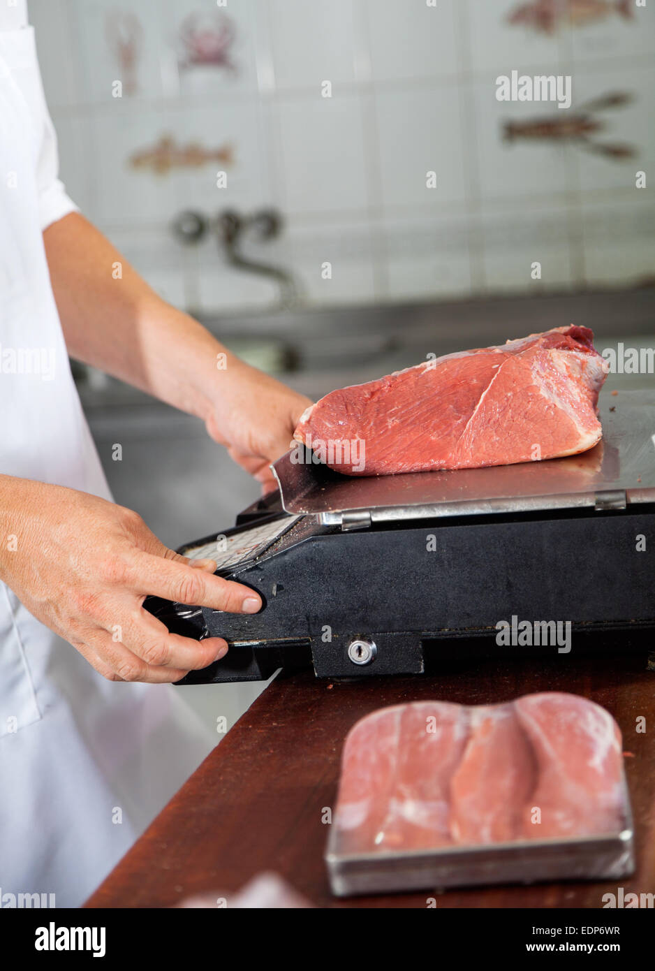 Butcher Weighing Meat On Weight Scale Stock Photo Alamy