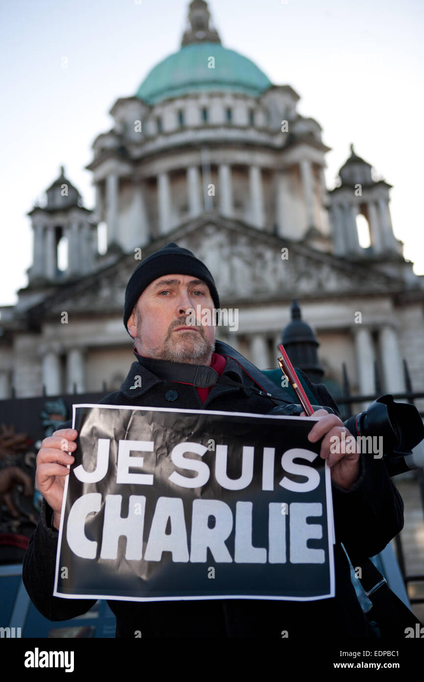 Belfast,UK,8th January 2015 Photographer, Kevin Cooper who is a member of the NUJ holding a Je Suis Charlie poster outside Belfast City Hall. the Silent Vigil was held in Remembrance of those killed in the Paris Attack Credit:  Bonzo/Alamy Live News Stock Photo