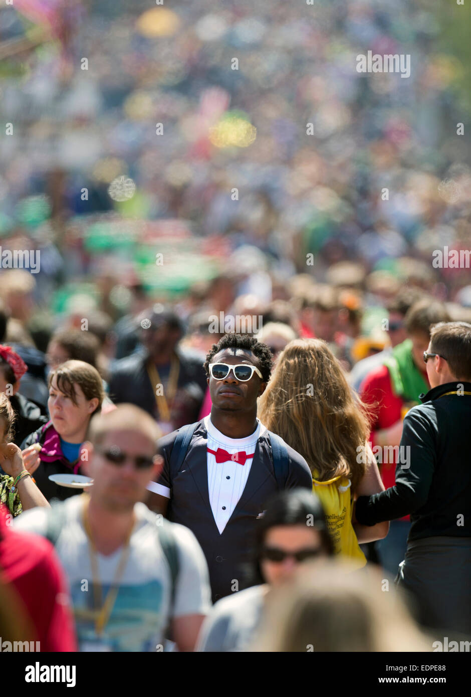 Crowds streaming along a busy walkway at Glastonbury June 2014 UK Stock Photo