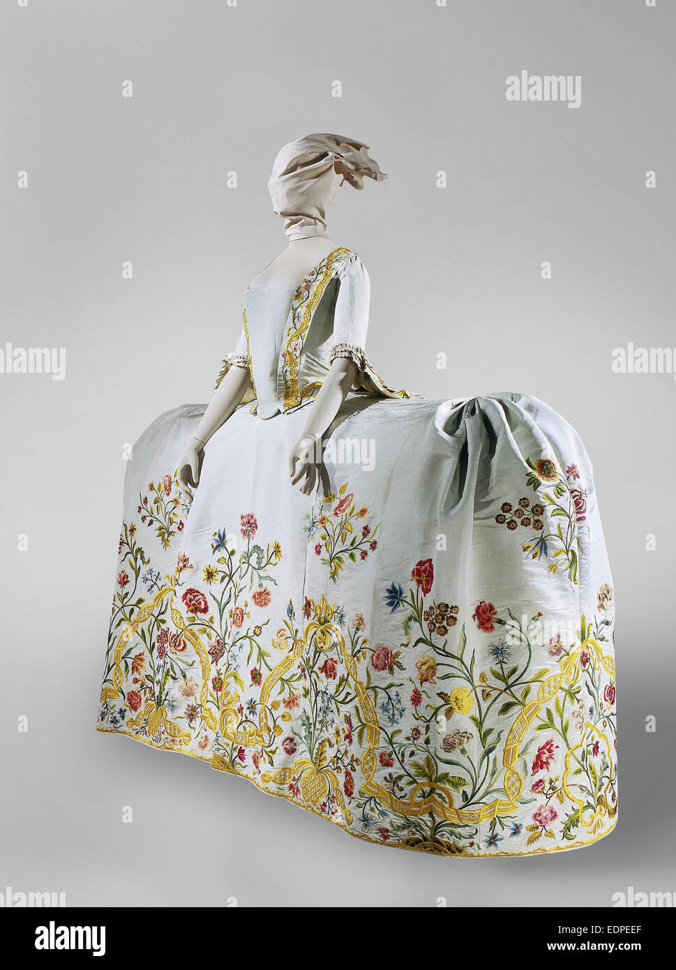 Wedding gown of pale blue silk rep embroidered with a floral motif in multicolored silk, consisting of a body with 'tail', skirt Stock Photo