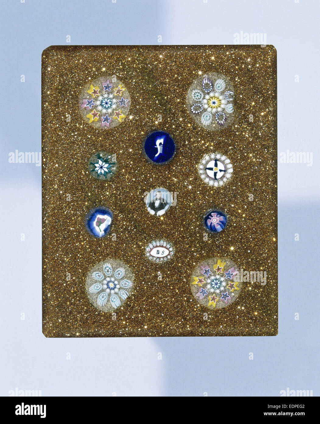 Plaque of aventurine glass, with eleven rosettes of millefiori glass, the middle with a portrait of Camillo Benso, Count Cavour Stock Photo