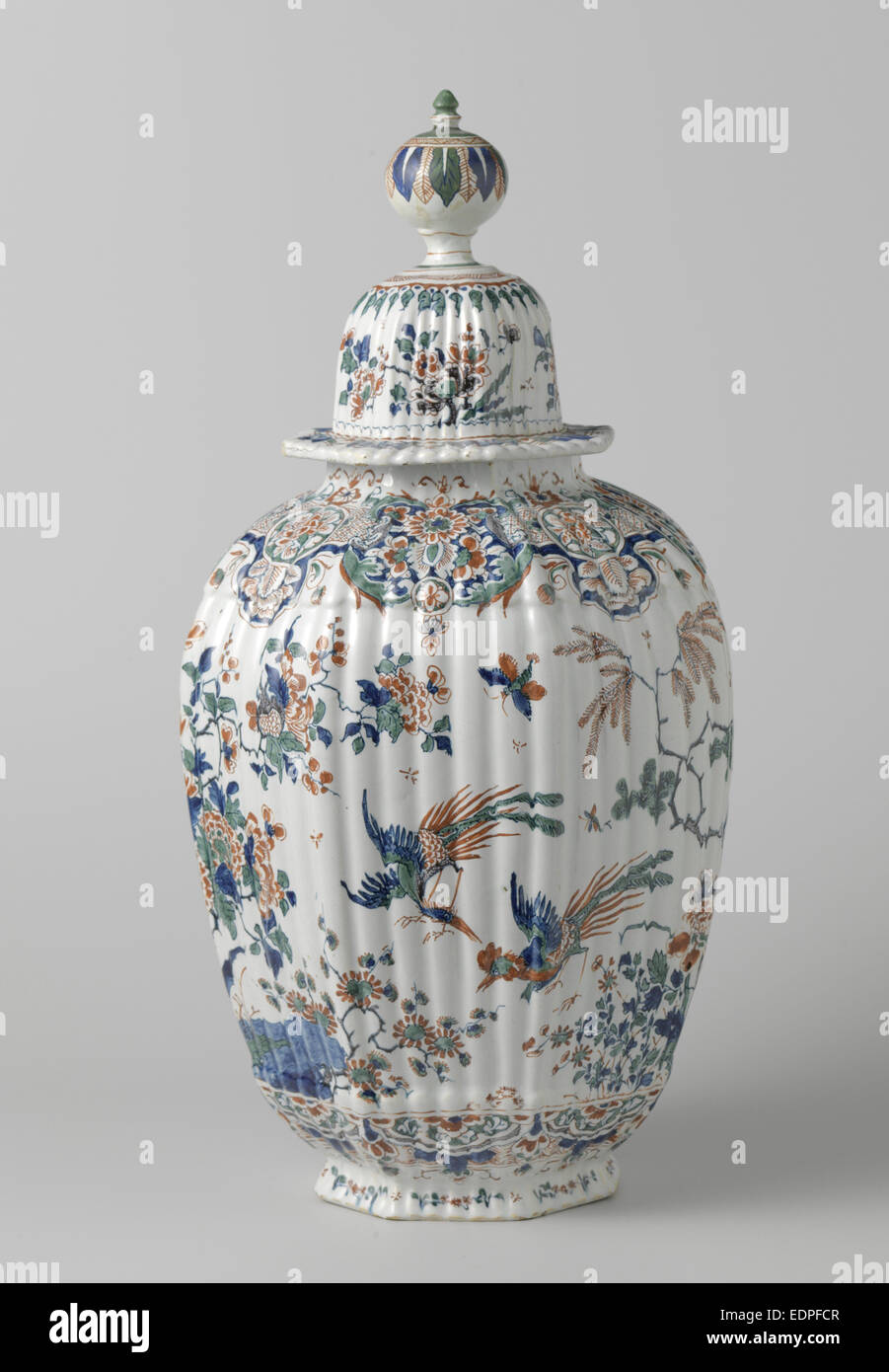 Octagonal ribbed vase with lid multicolored painted faience Stock Photo