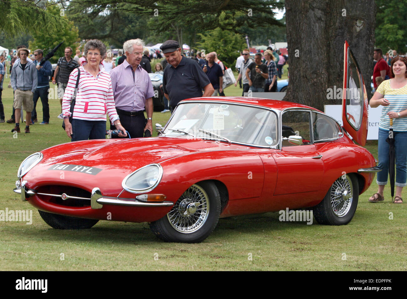 A Mark 1 Jaguar E-Type draws the attention at a classic car show in Wiltshire, England in 2014. Stock Photo