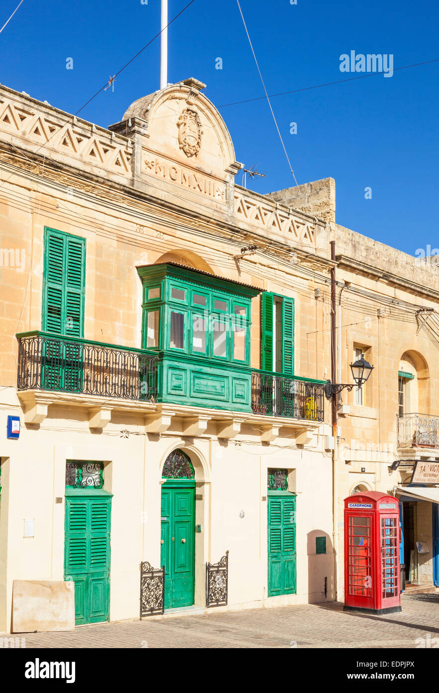 Traditional Green Balcony and Red Telephone Box Marsaxlokk Malta EU Europe Stock Photo