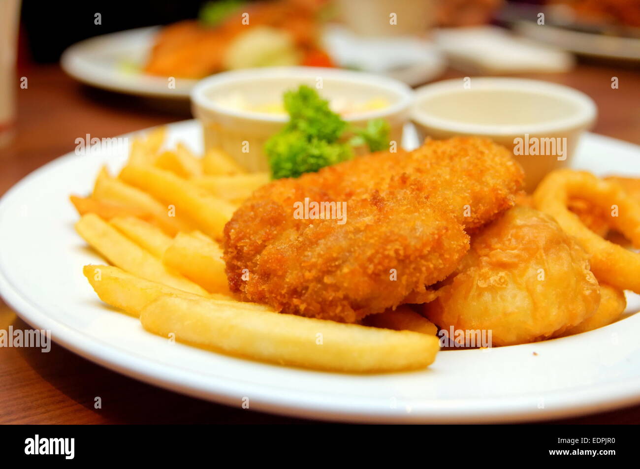 Chicken and fish cutlets with french fries Stock Photo