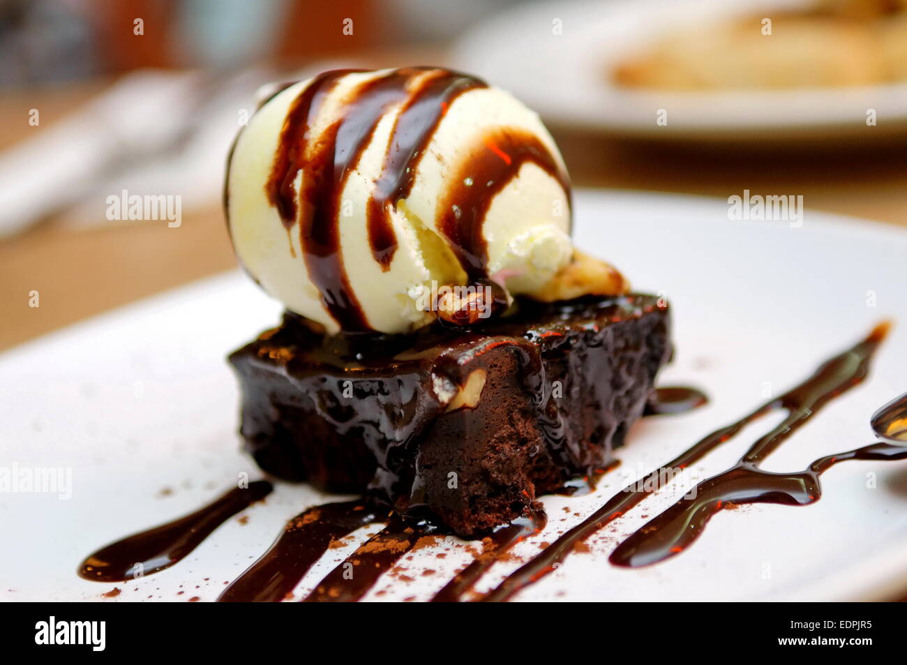 Chocolate Brownie With Vanilla Ice cream And Chocolate Sauce Stock chocolate-brownie-with-vanilla-ice-cream-and-chocolate-sauce-stock