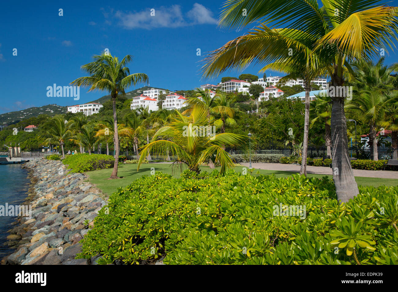 Walkway along the waterfront with wealthy rental properties beyond in