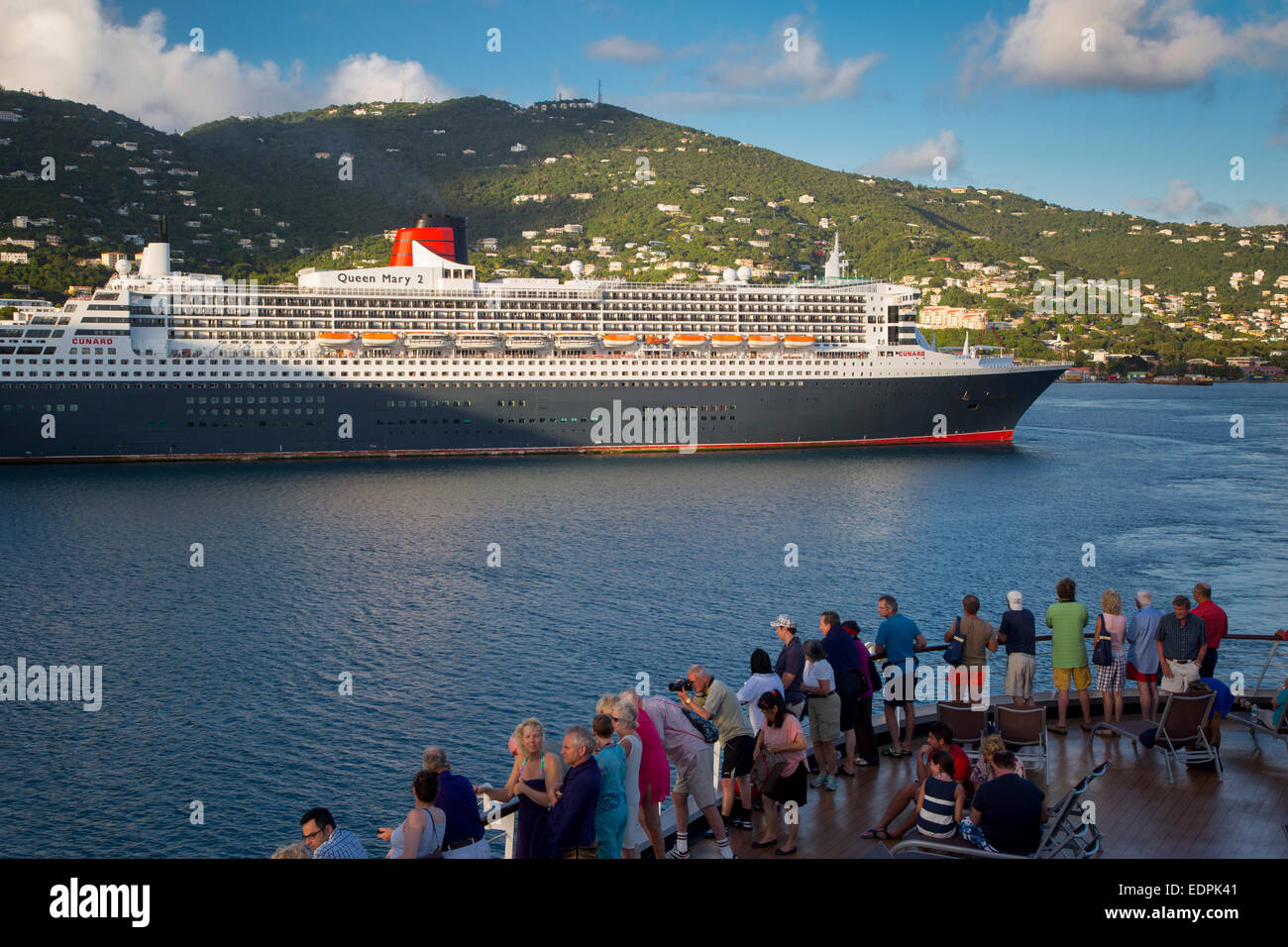 Passengers aboard Cruise ship view the Queen Mary II Cruise Ship docked