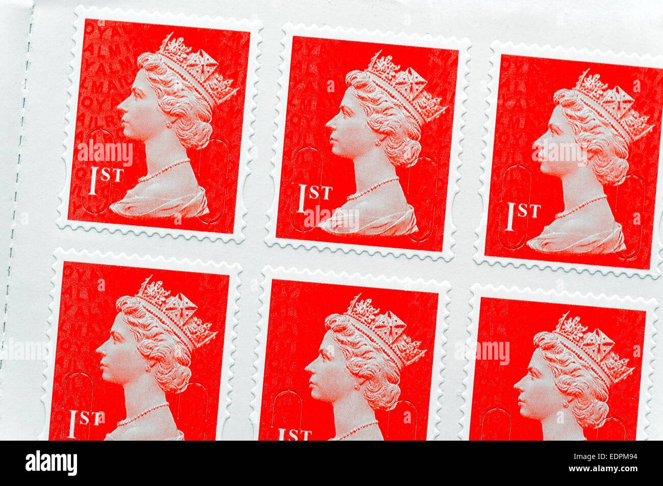 Red British first class royal mail postage stamps Stock Photo