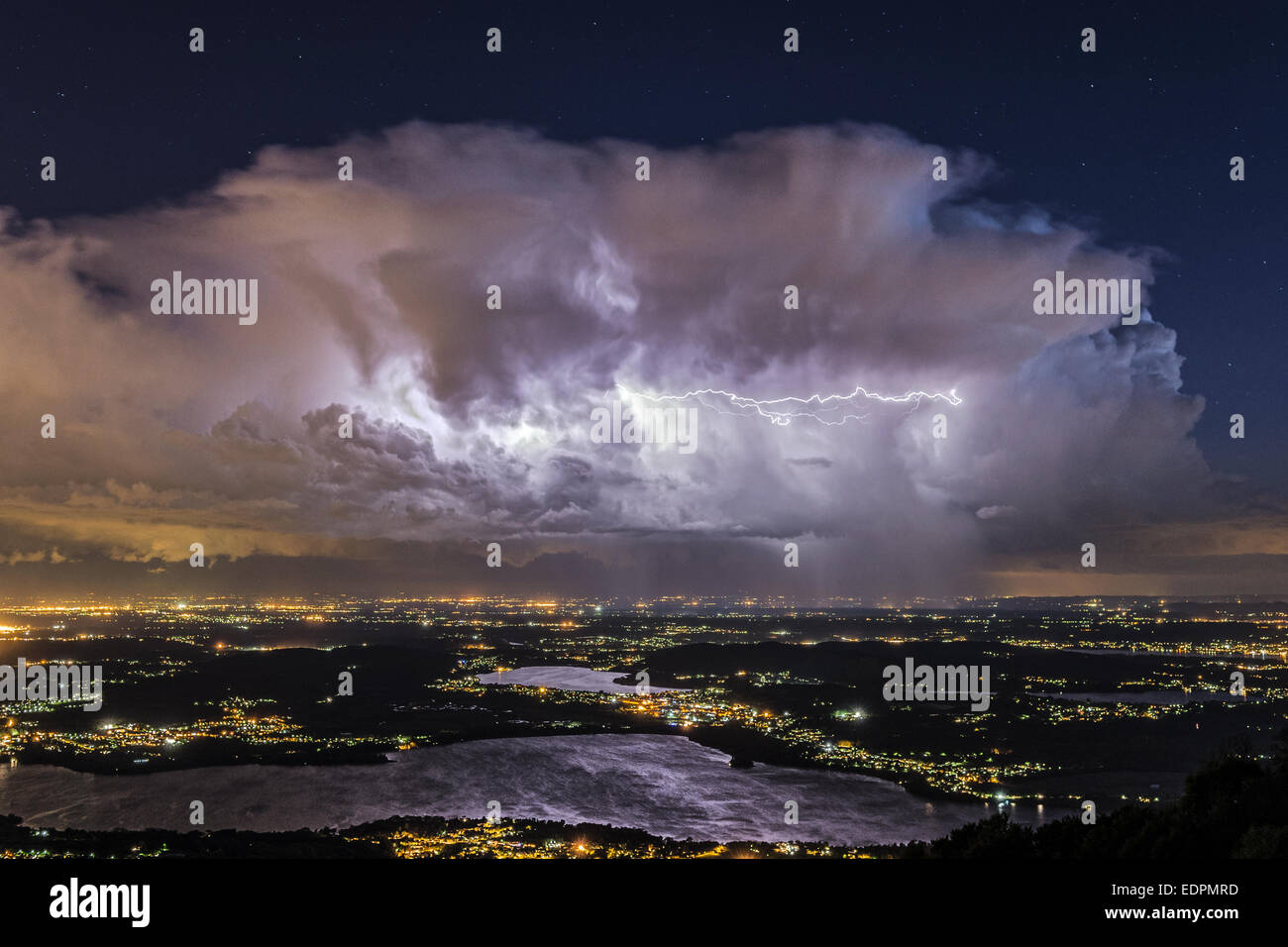 Lake of Varese in the night and thunderstorm at the horizon seen from Regional Park of Campo dei Fiori Stock Photo