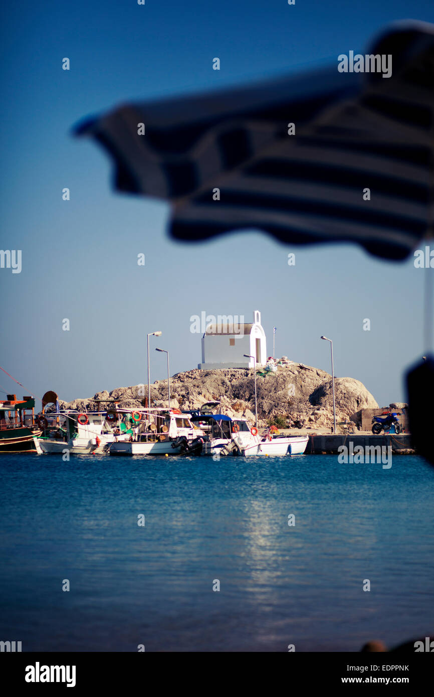 Kolymbia beach bay. View on the little white church from the shore. Rhodes, Greece Stock Photo