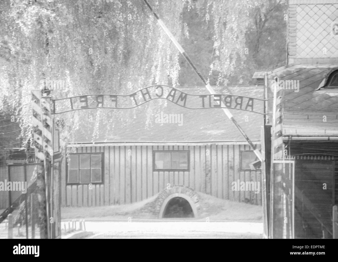 Arbeit Macht Frei - Work Makes You Free sign over entrance gate at the Auschwitz concentration camp, Auschwitz Poland - infrared Stock Photo