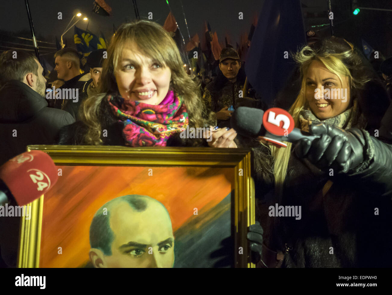 Jan. 1, 2015 - LifeNews journalist Zhanna Karpenko (R) interviews marchers. - Police detained a suspect in the attack on journalists during a torch procession January 1, 2015 in Kiev, Ukraine, in honor of the 106th anniversary of the birth of the conductor OUN Stepan Bandera. The collision damaged the camera operator, while the journalist's mobile phone. The assailant was charged with obstruction of the lawful professional activities of journalists and robbery. (Credit Image: © Igor Golovniov/ZUMA Wire) Stock Photo