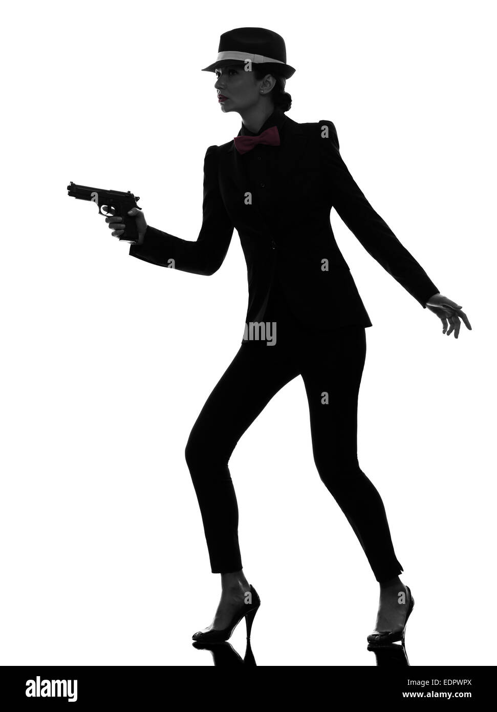 one stylish  woman in suit holding gun in silhouette on white background Stock Photo